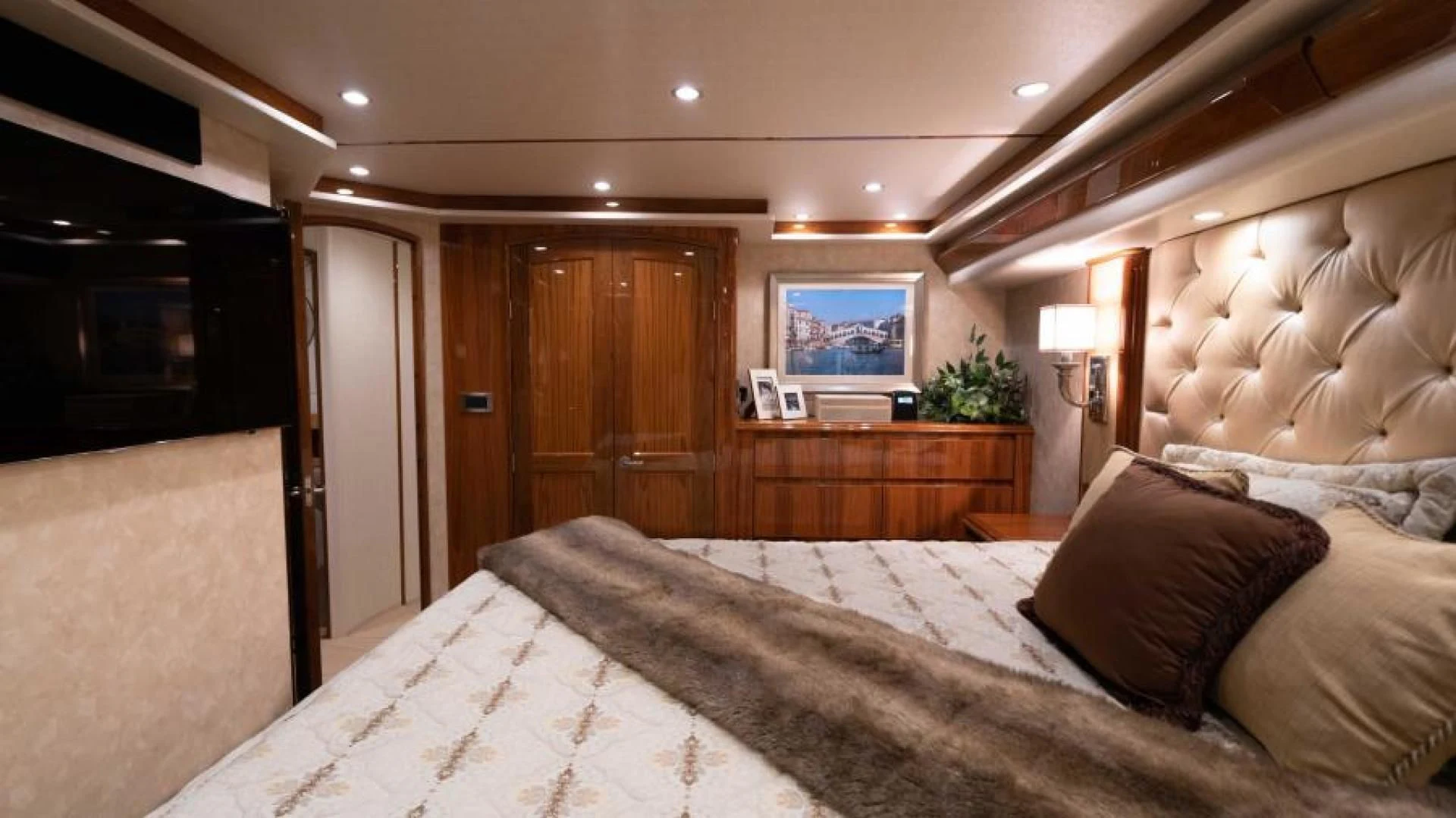 a bed with pillows aboard NEVER TOO LATE Yacht for Charter