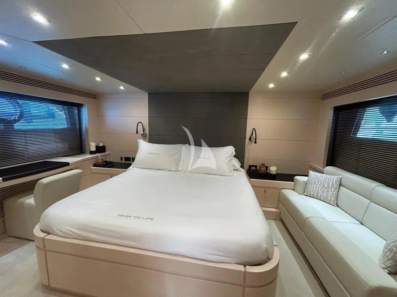 a hotel room with a large bed aboard NEVER TOO LATE Yacht for Charter
