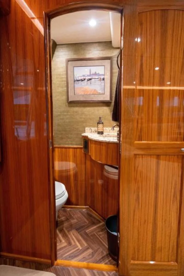 a bathroom with a wood door aboard NEVER TOO LATE Yacht for Charter