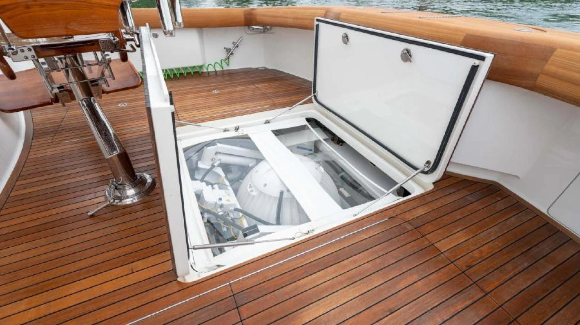 a white rectangular box with a silver lid on a wooden surface aboard NEVER TOO LATE Yacht for Charter