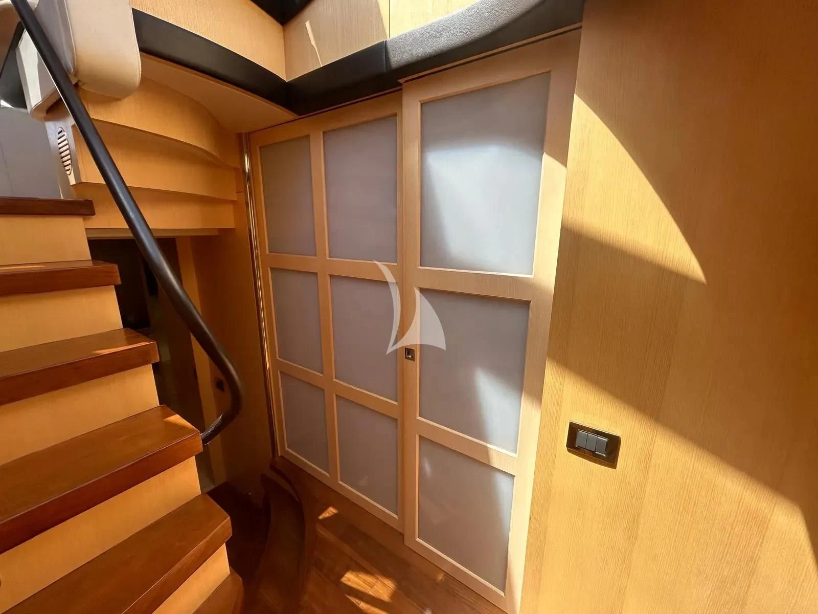 a wooden door with a light on it aboard NEVER TOO LATE Yacht for Charter