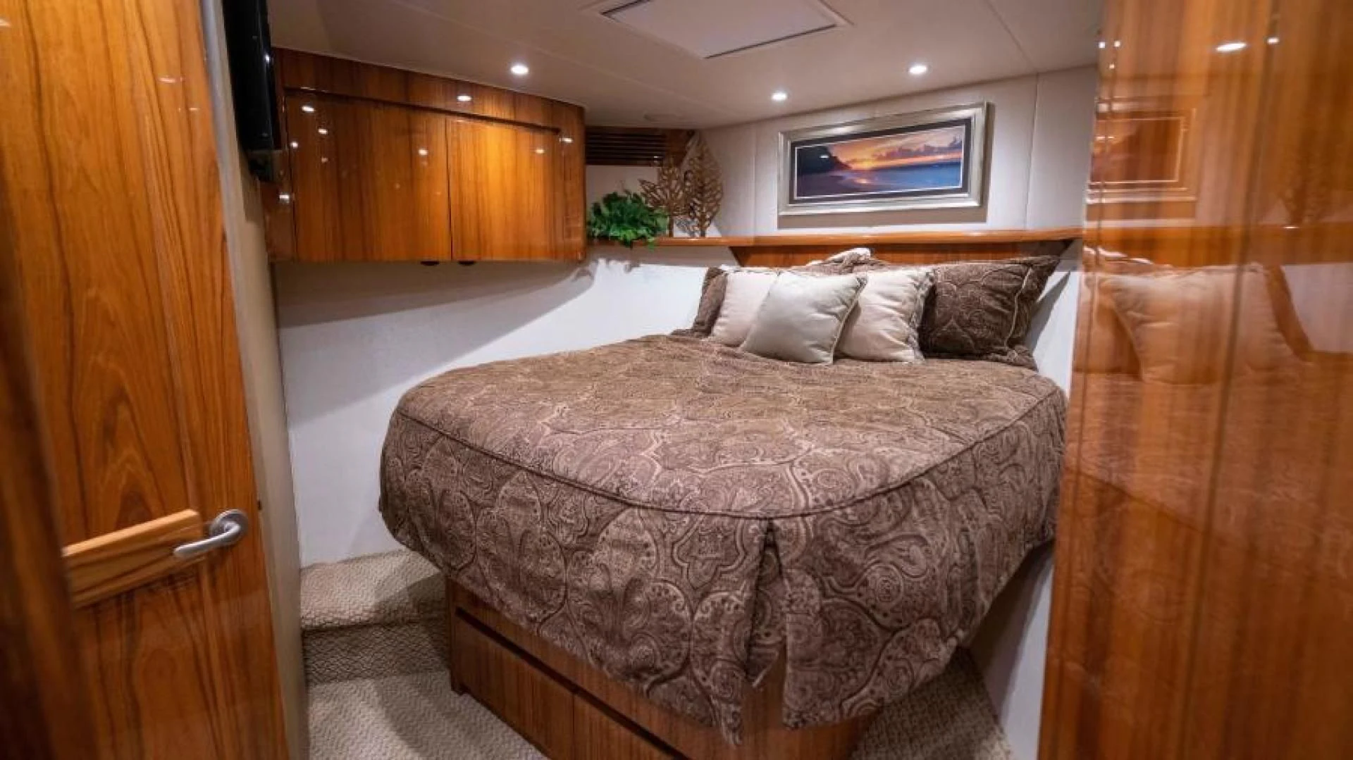 a bed in a room aboard NEVER TOO LATE Yacht for Charter