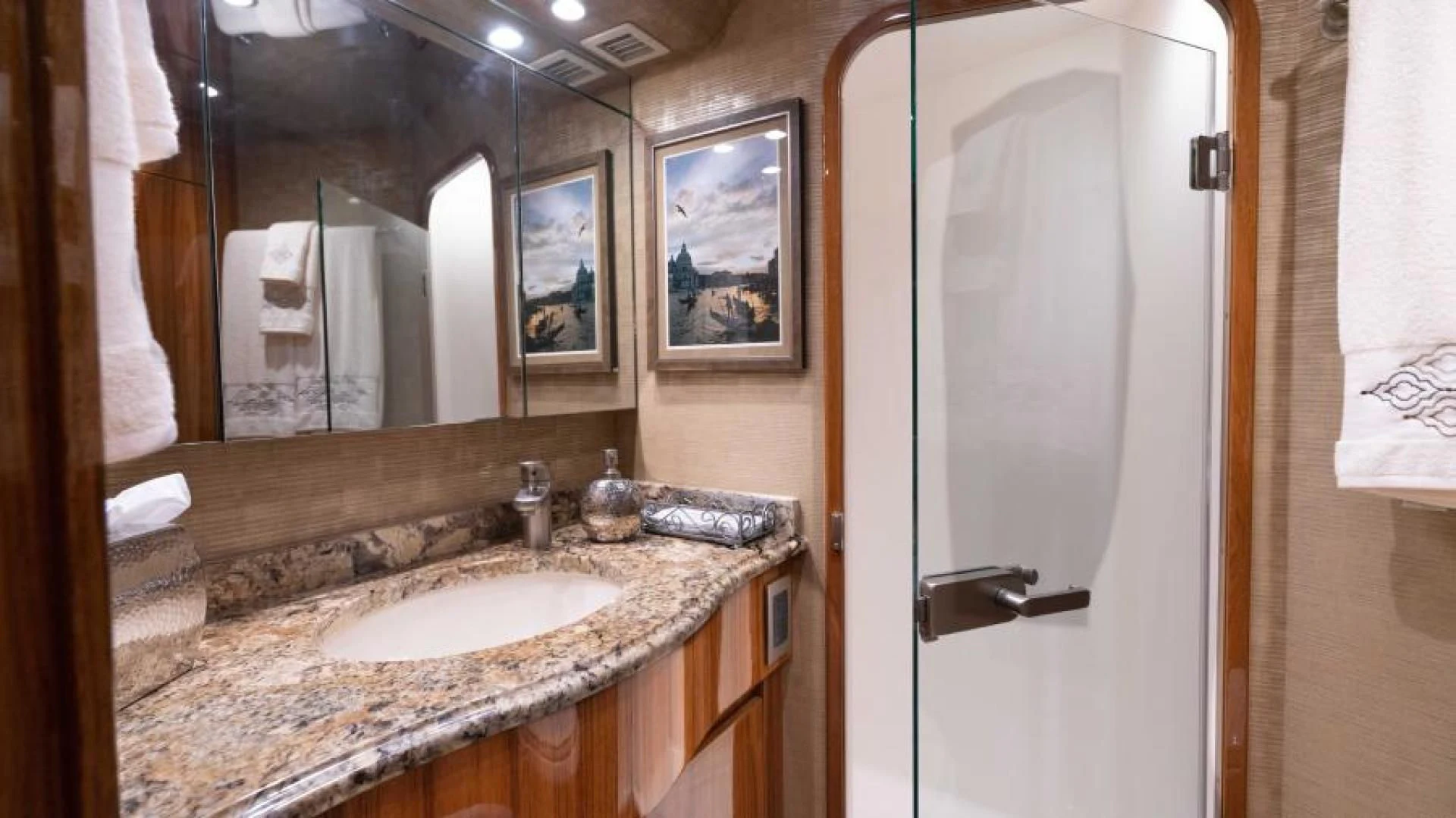 a bathroom with a sink and mirror aboard NEVER TOO LATE Yacht for Charter