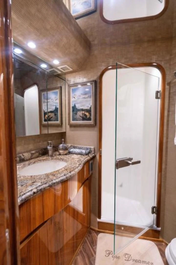 a bathroom with a glass shower door aboard NEVER TOO LATE Yacht for Charter
