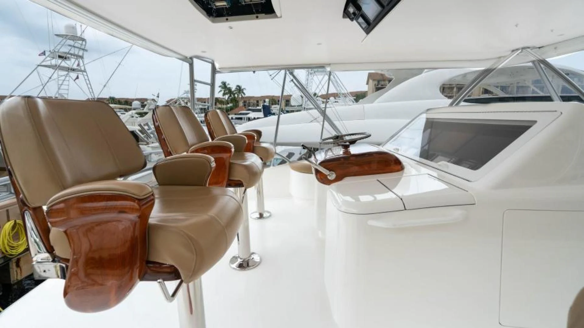 a white yacht with a brown seat aboard NEVER TOO LATE Yacht for Charter