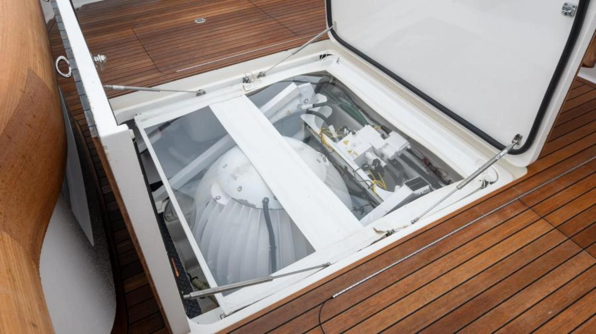 a white rectangular object on a wooden surface aboard NEVER TOO LATE Yacht for Charter