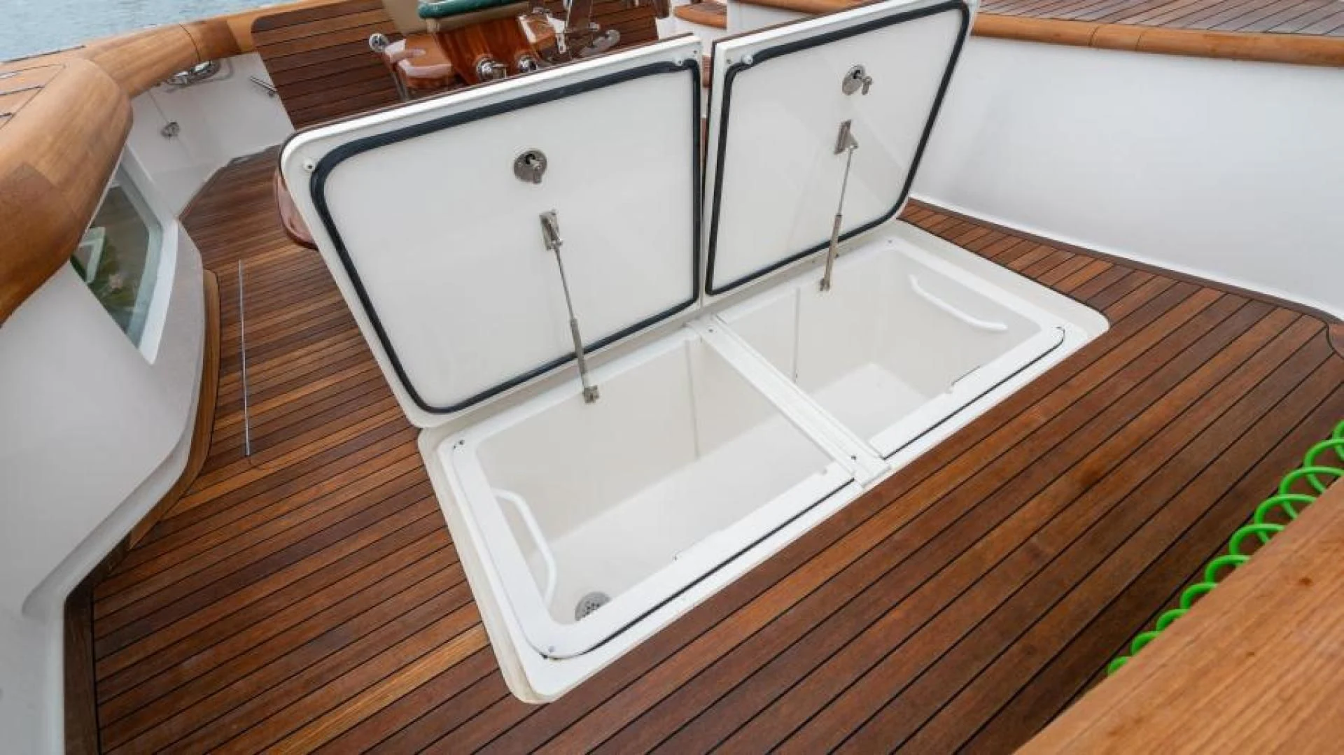 a white rectangular object on a wooden surface aboard NEVER TOO LATE Yacht for Charter