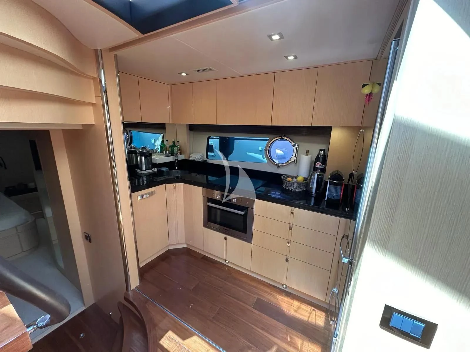 a kitchen with wooden cabinets aboard NEVER TOO LATE Yacht for Charter
