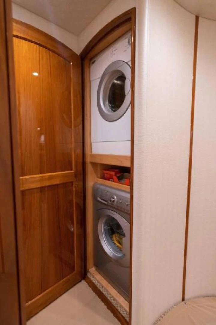 a washer and dryer in a room aboard NEVER TOO LATE Yacht for Charter