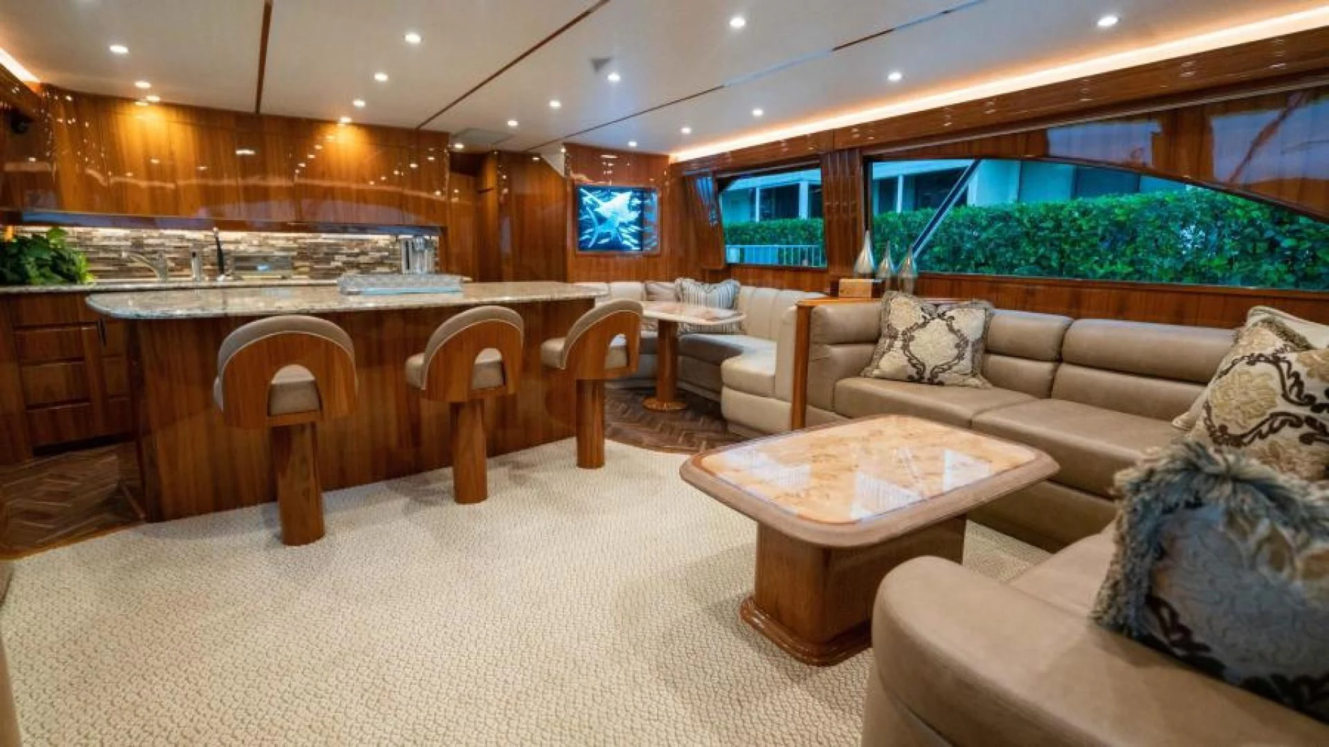 a large living room with a large table and chairs aboard NEVER TOO LATE Yacht for Charter