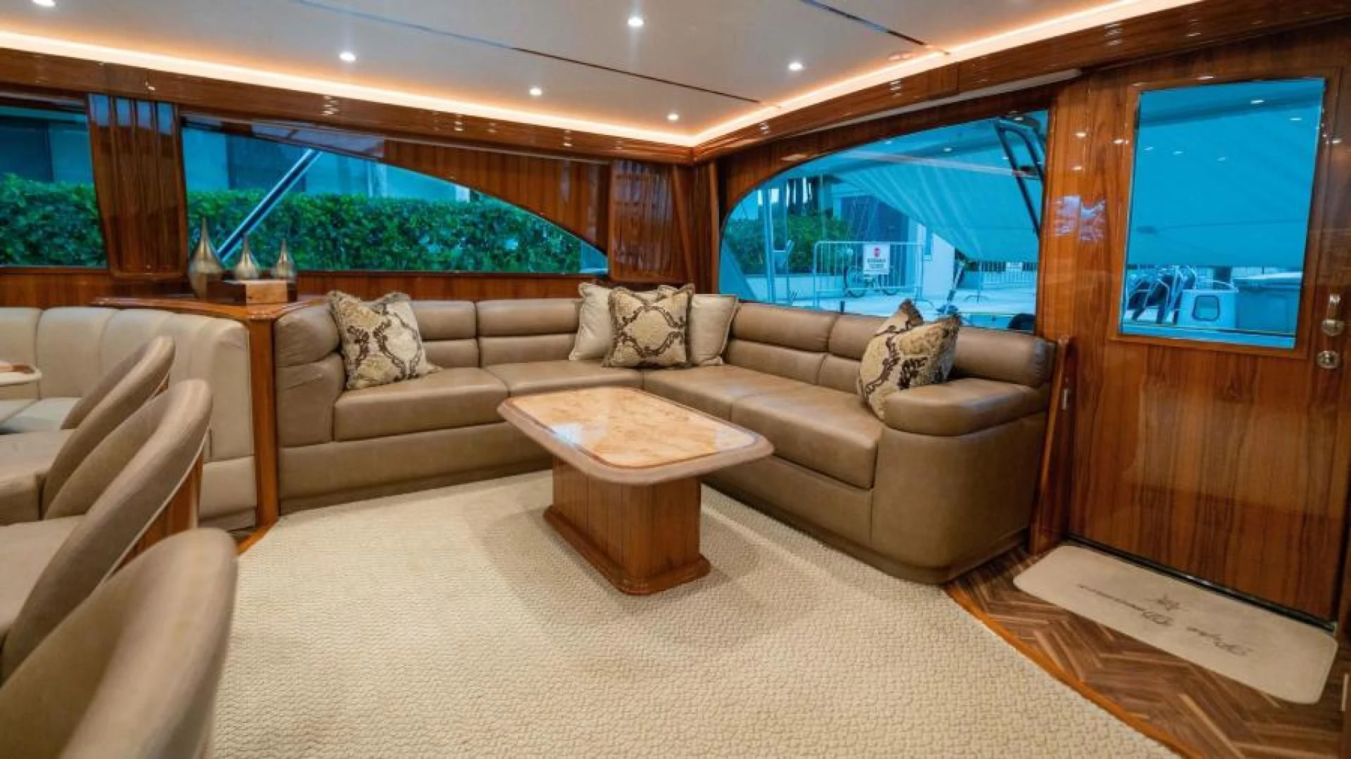 a living room with a large window aboard NEVER TOO LATE Yacht for Charter