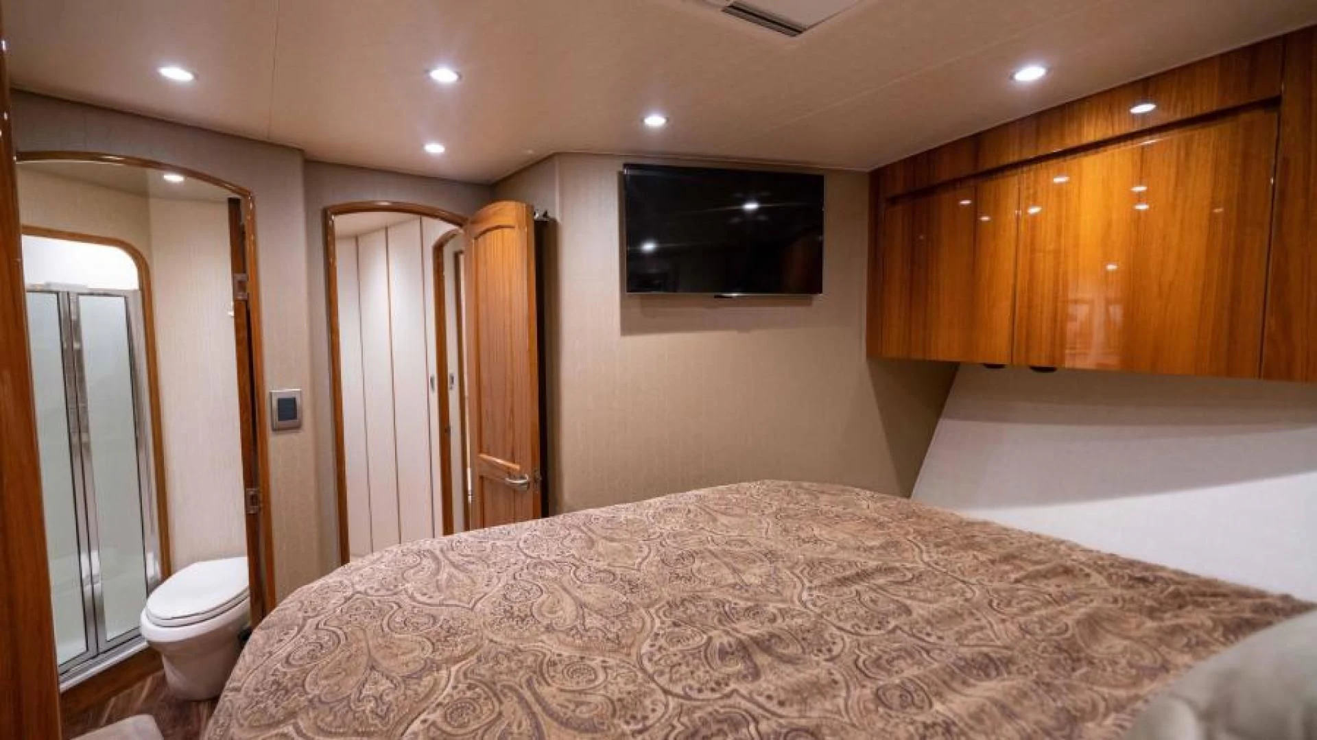 a large bedroom with a large bed aboard NEVER TOO LATE Yacht for Charter
