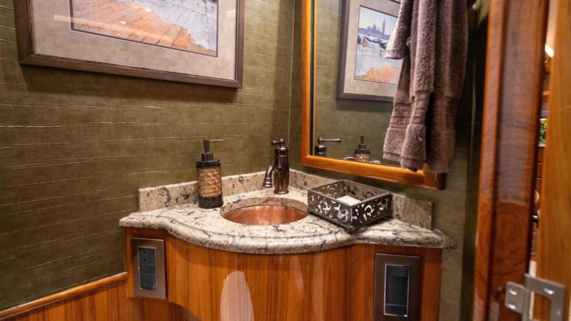 a bathroom with a sink and a mirror aboard NEVER TOO LATE Yacht for Charter