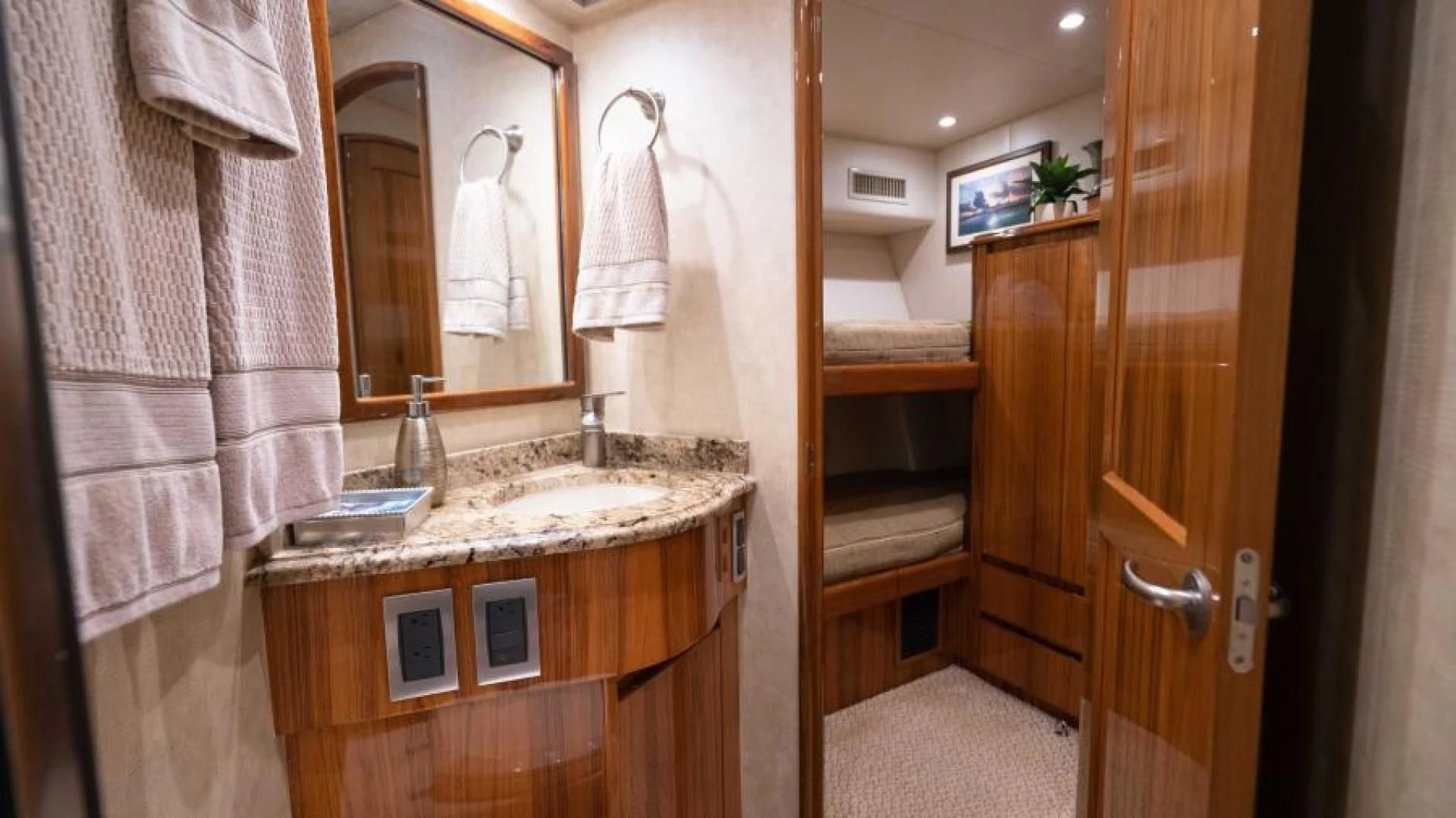 a bathroom with a sink and towels aboard NEVER TOO LATE Yacht for Charter