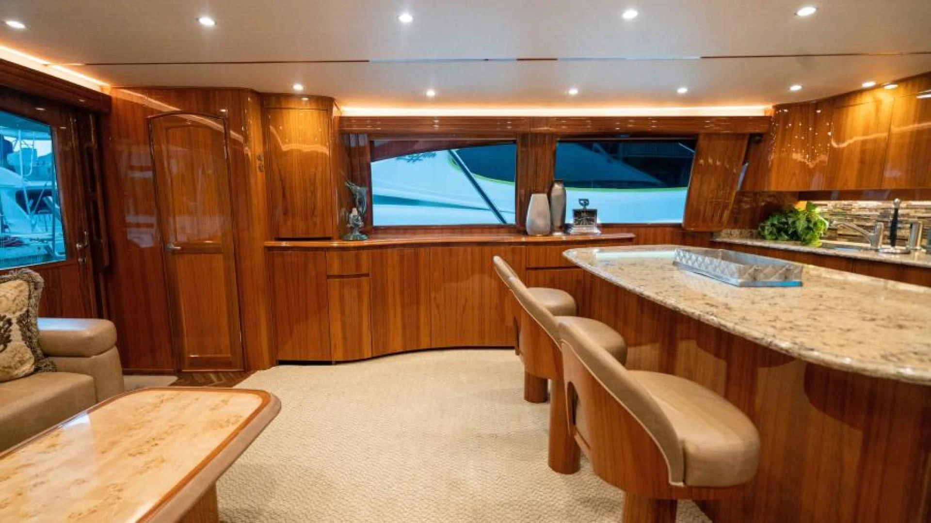 a room with a table and chairs aboard NEVER TOO LATE Yacht for Charter
