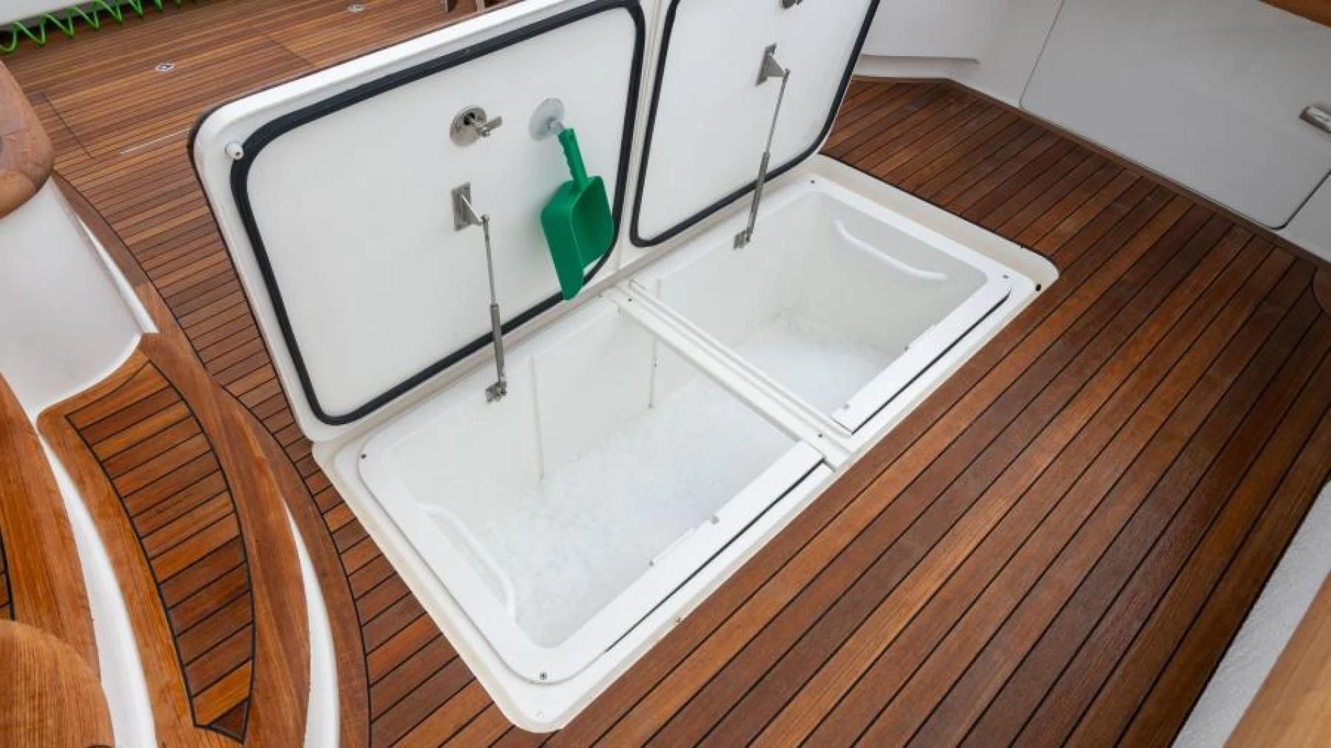 a white rectangular object on a wooden surface aboard NEVER TOO LATE Yacht for Charter