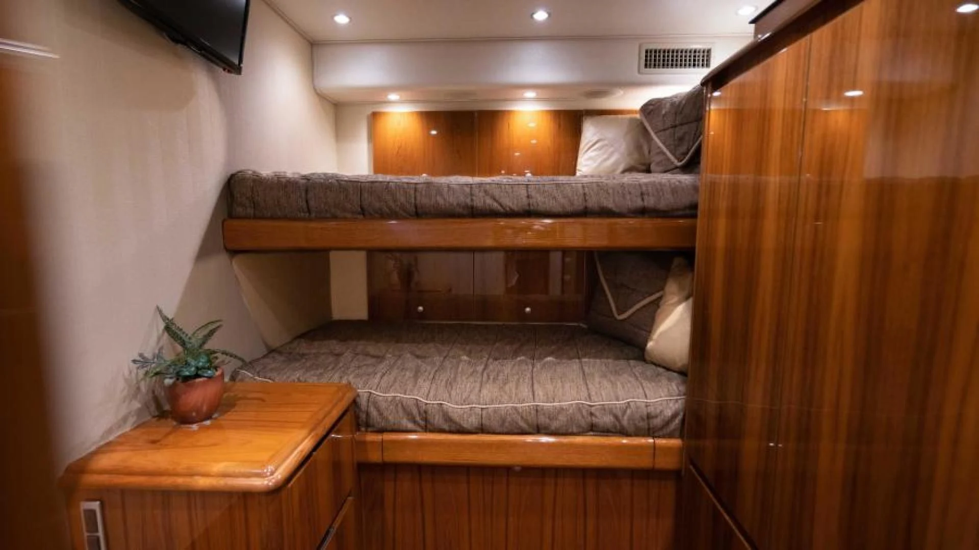 a couch and a table in a room aboard NEVER TOO LATE Yacht for Charter