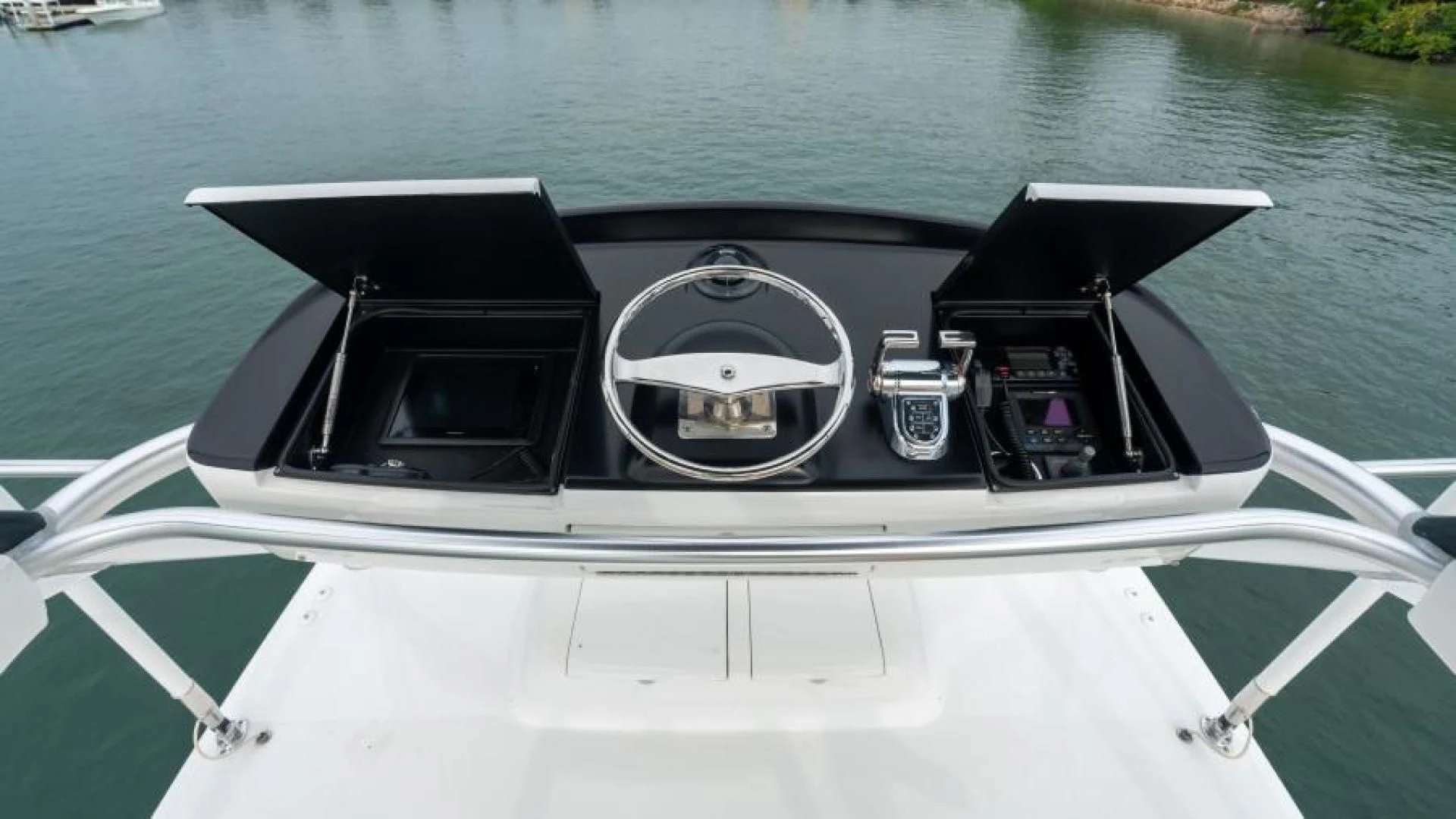 a boat with a steering wheel aboard NEVER TOO LATE Yacht for Charter