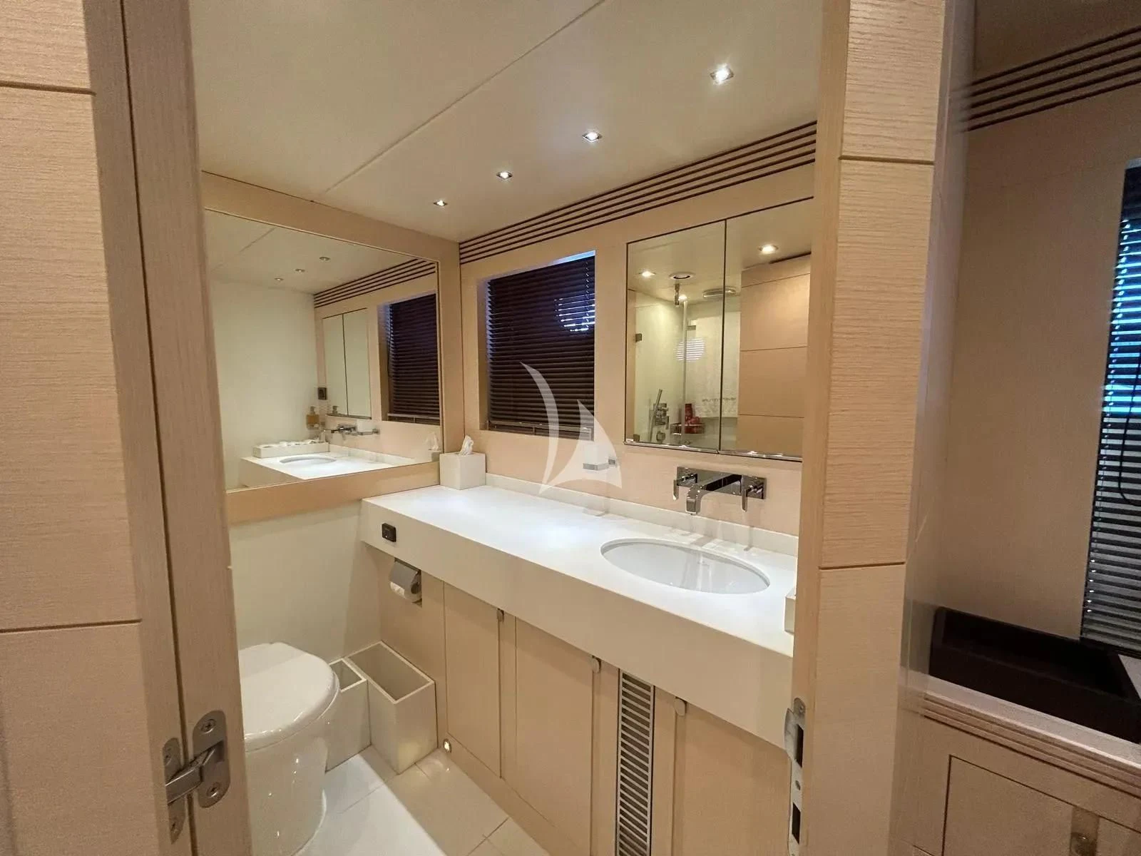 a bathroom with a sink and a mirror aboard NEVER TOO LATE Yacht for Charter