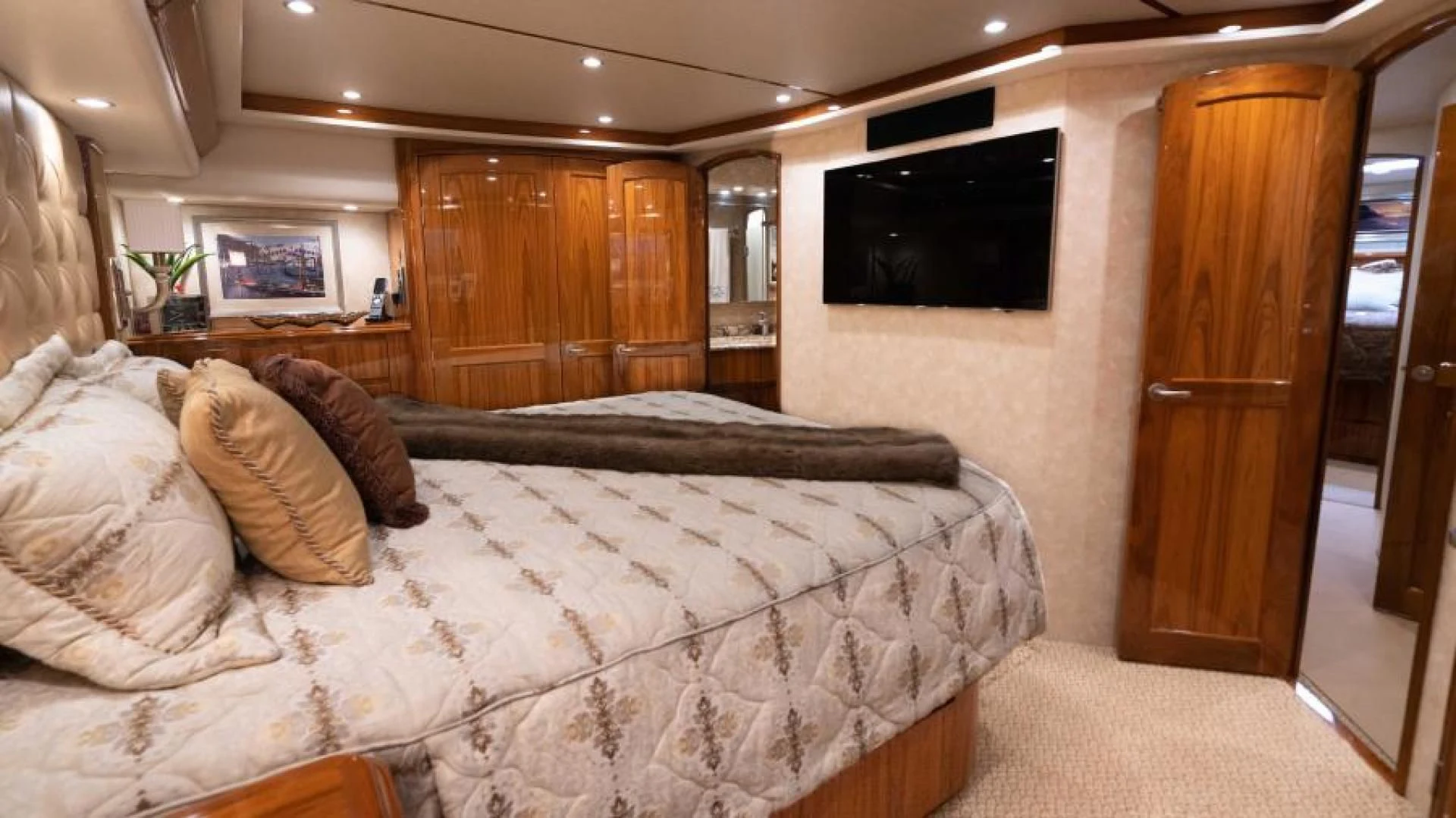 a hotel room with a bed and tv aboard NEVER TOO LATE Yacht for Charter