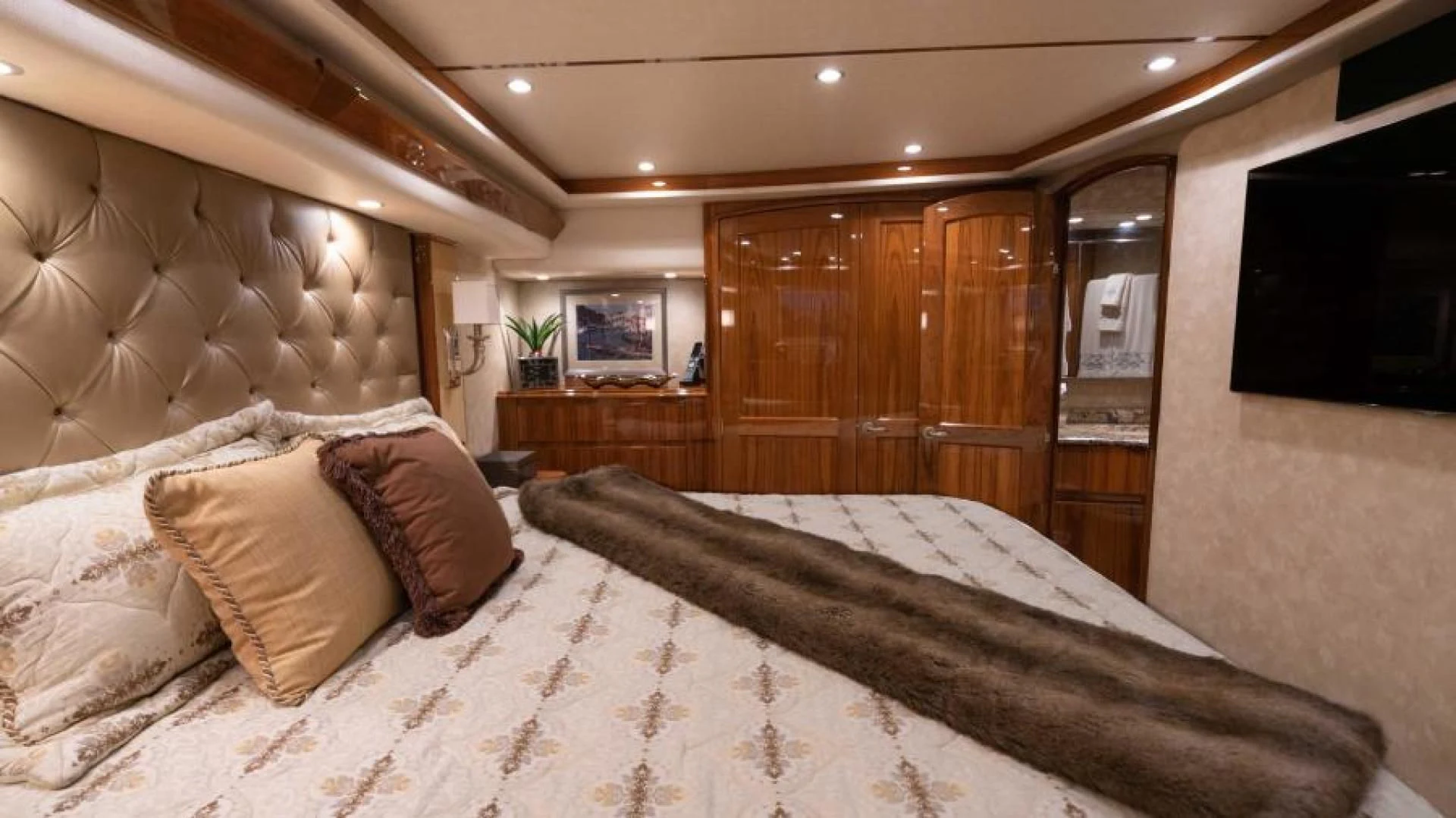 a bed with pillows aboard NEVER TOO LATE Yacht for Charter