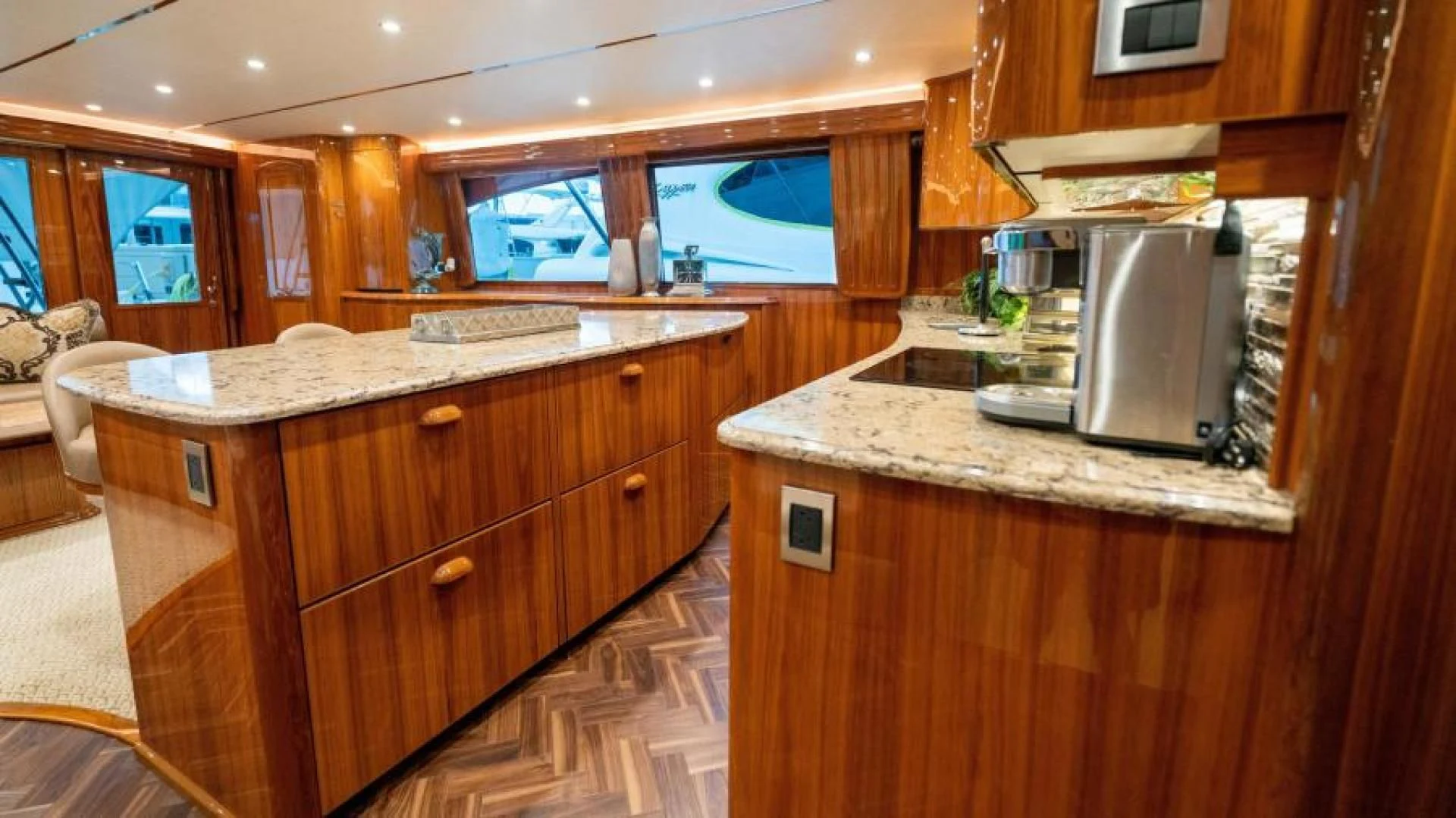 a kitchen with wooden cabinets aboard NEVER TOO LATE Yacht for Charter
