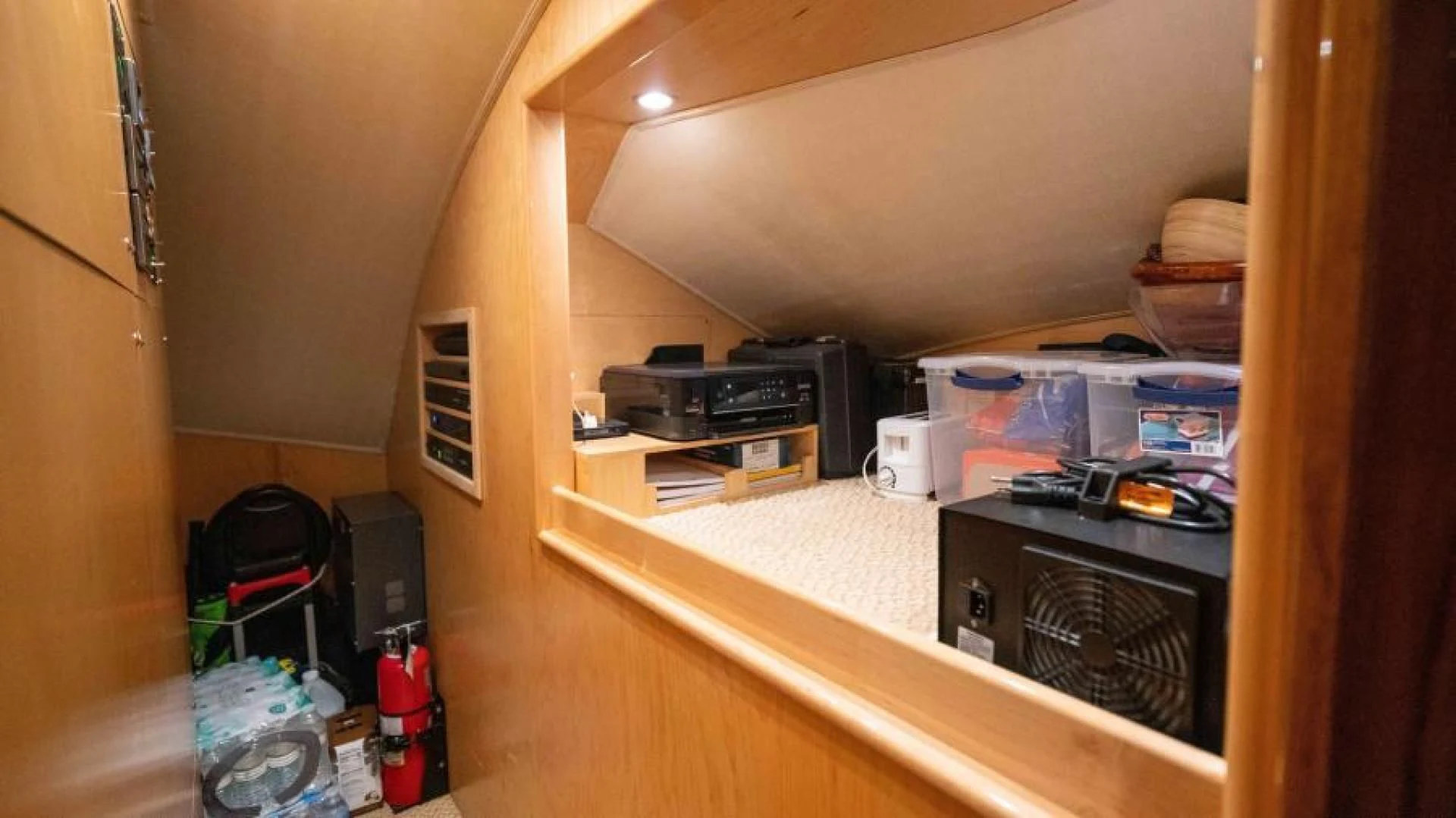 a room with a wood shelf and a fan aboard NEVER TOO LATE Yacht for Charter