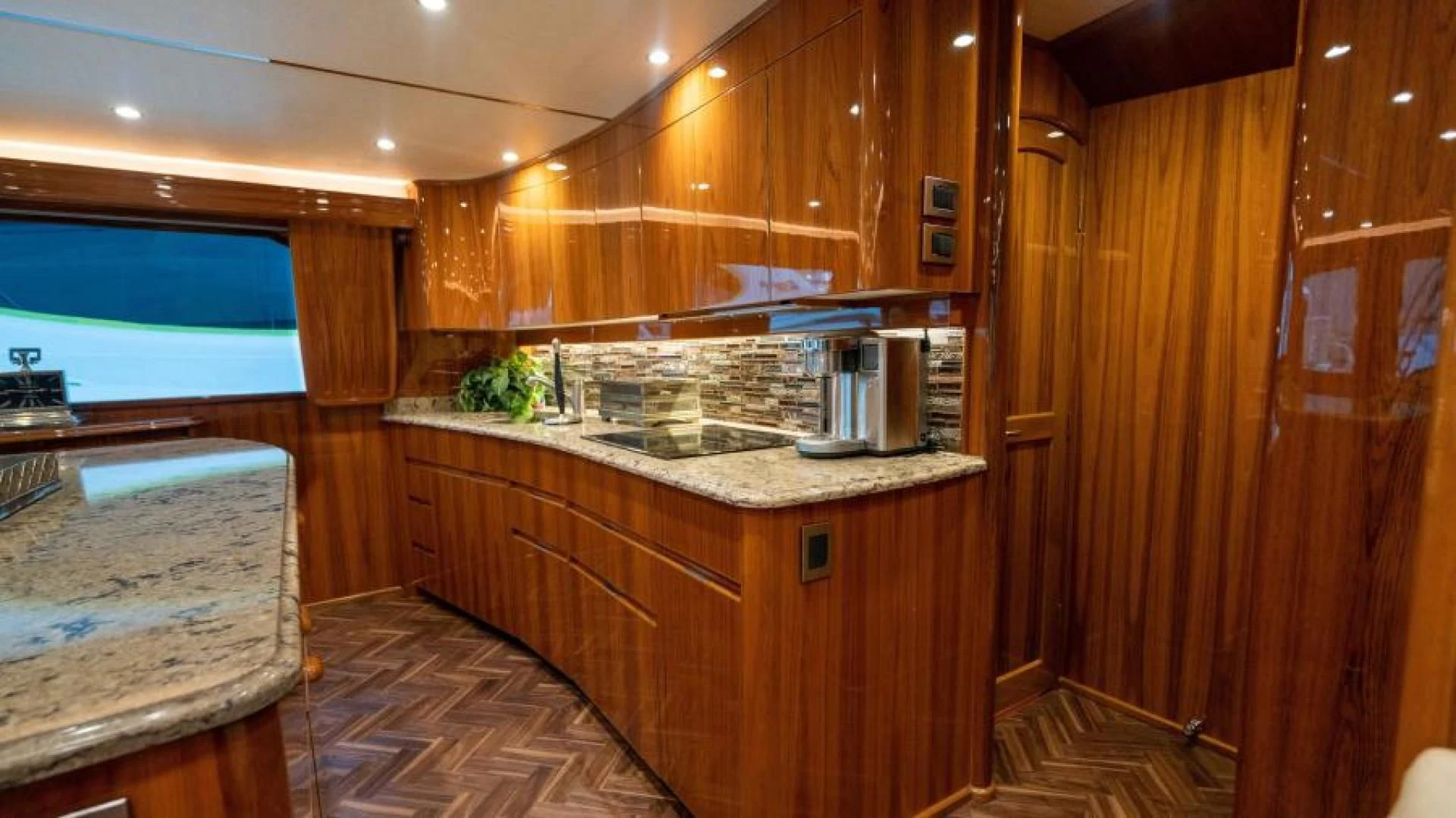 a kitchen with wooden cabinets aboard NEVER TOO LATE Yacht for Charter
