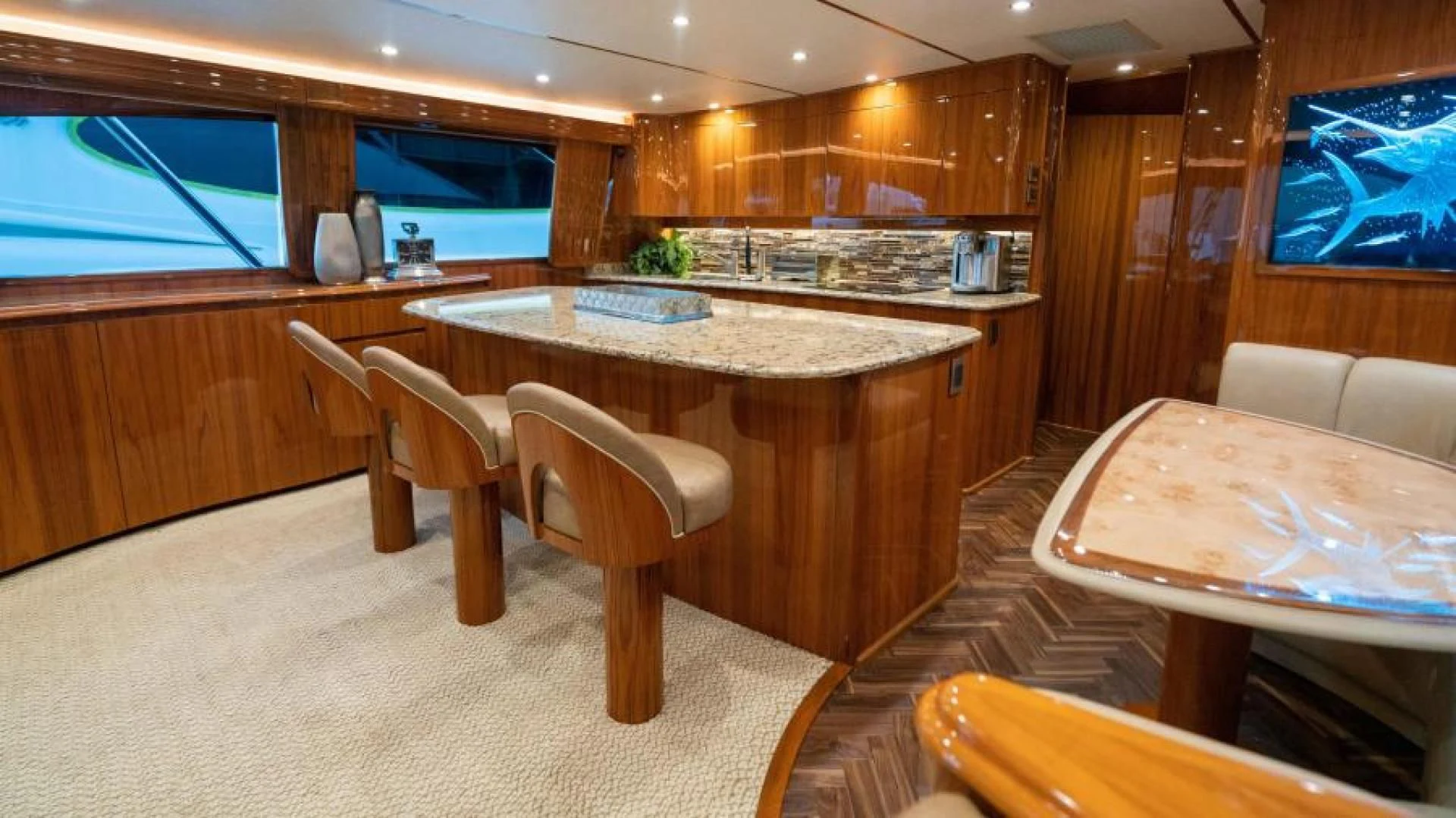 a kitchen with a table and chairs aboard NEVER TOO LATE Yacht for Charter