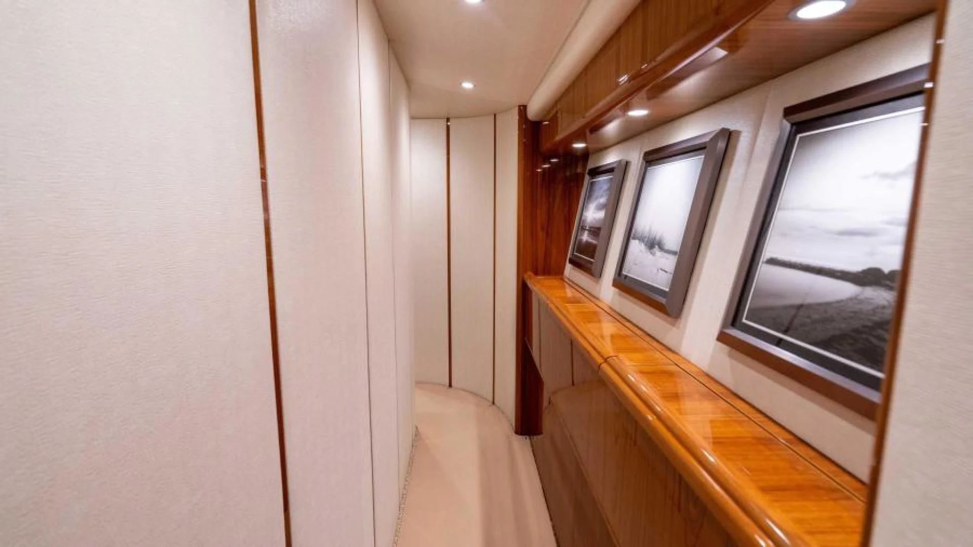 a room with a window and a wood railing aboard NEVER TOO LATE Yacht for Charter