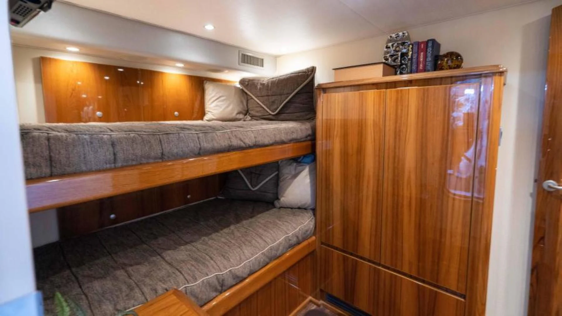 a couch and a dresser in a room aboard NEVER TOO LATE Yacht for Charter