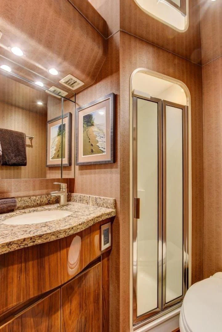 a bathroom with a large mirror aboard KICK'N Yacht for Sale