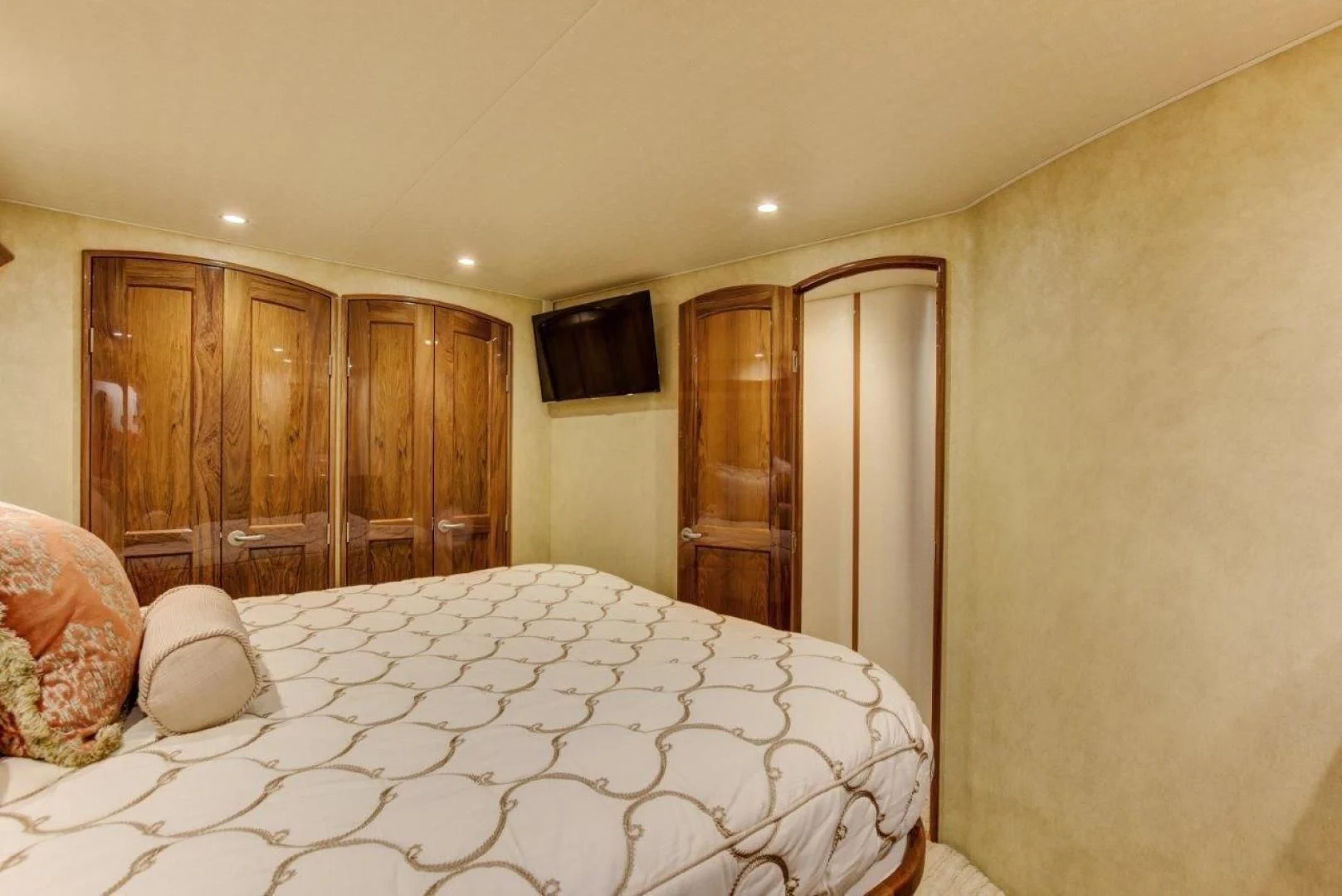 a bedroom with a bed and a television aboard KICK'N Yacht for Sale