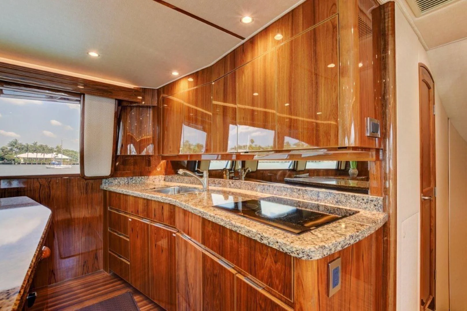 a kitchen with wooden cabinets aboard KICK'N Yacht for Sale
