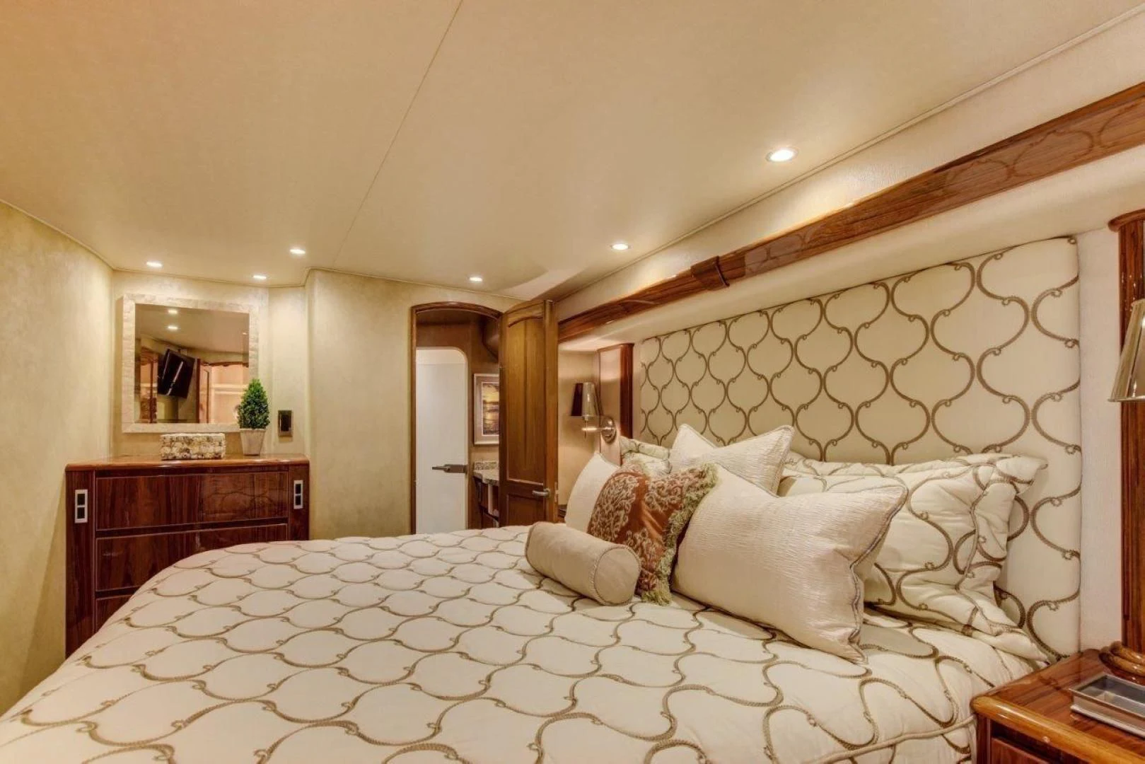 a large bed with white sheets aboard KICK'N Yacht for Sale