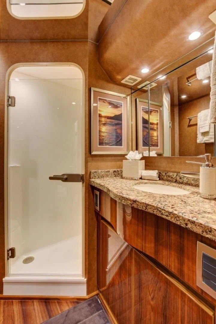 a bathroom with a large mirror aboard KICK'N Yacht for Sale