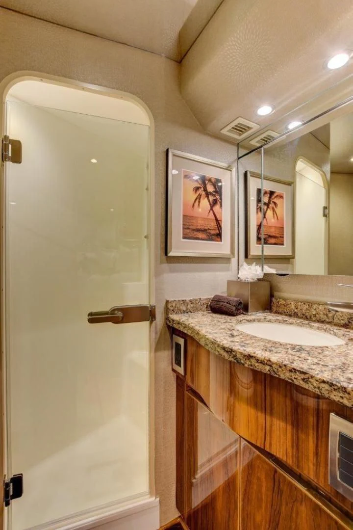 a bathroom with a countertop sink and a mirror aboard KICK'N Yacht for Sale