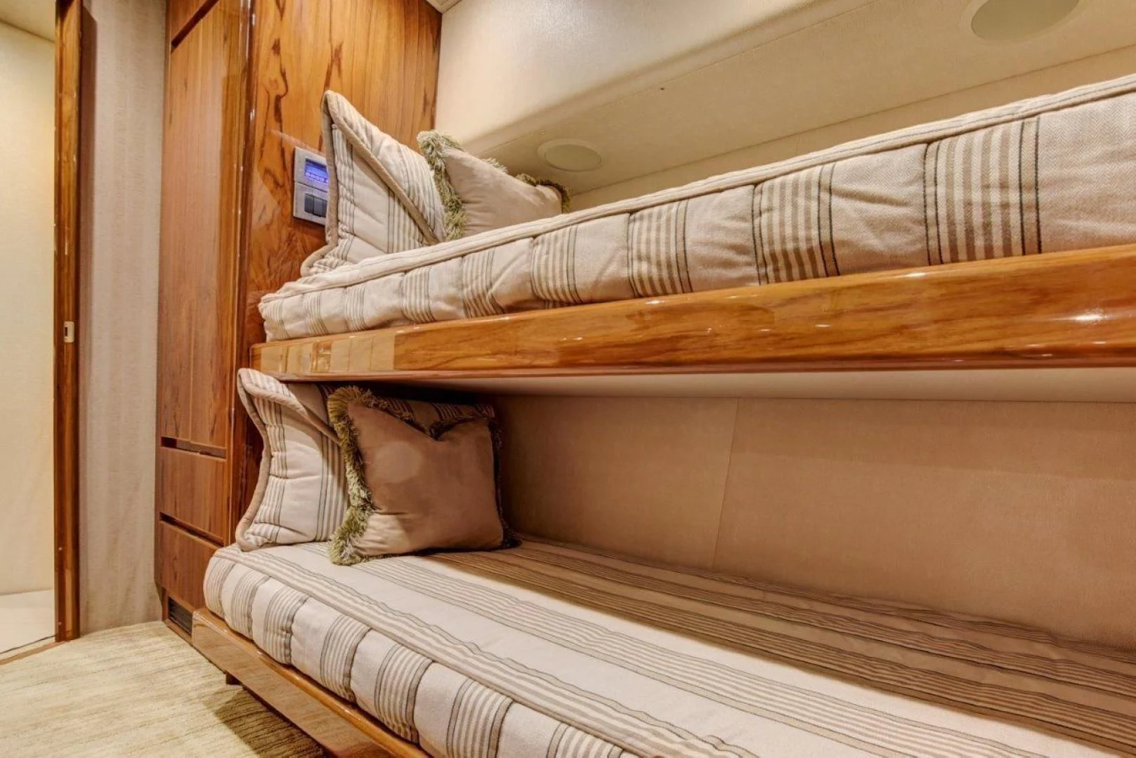 a bed with a striped sheet aboard KICK'N Yacht for Sale