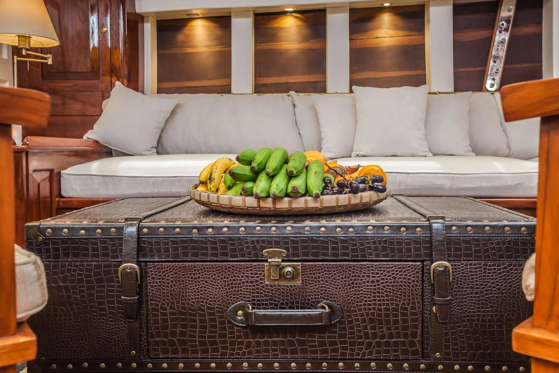 a basket of bananas sits on a suitcase aboard AVENTURE Yacht for Sale