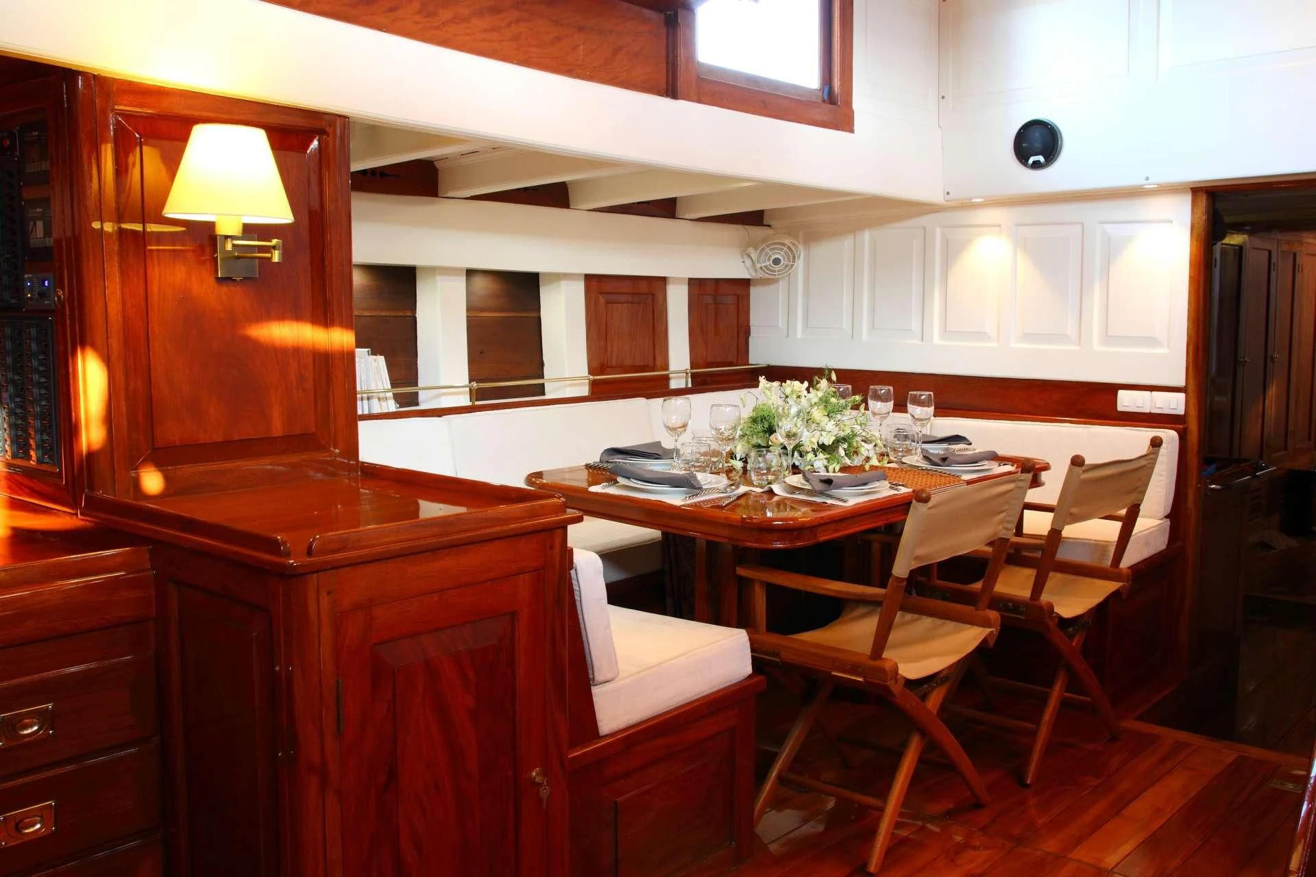 a kitchen with a table and chairs aboard AVENTURE Yacht for Sale