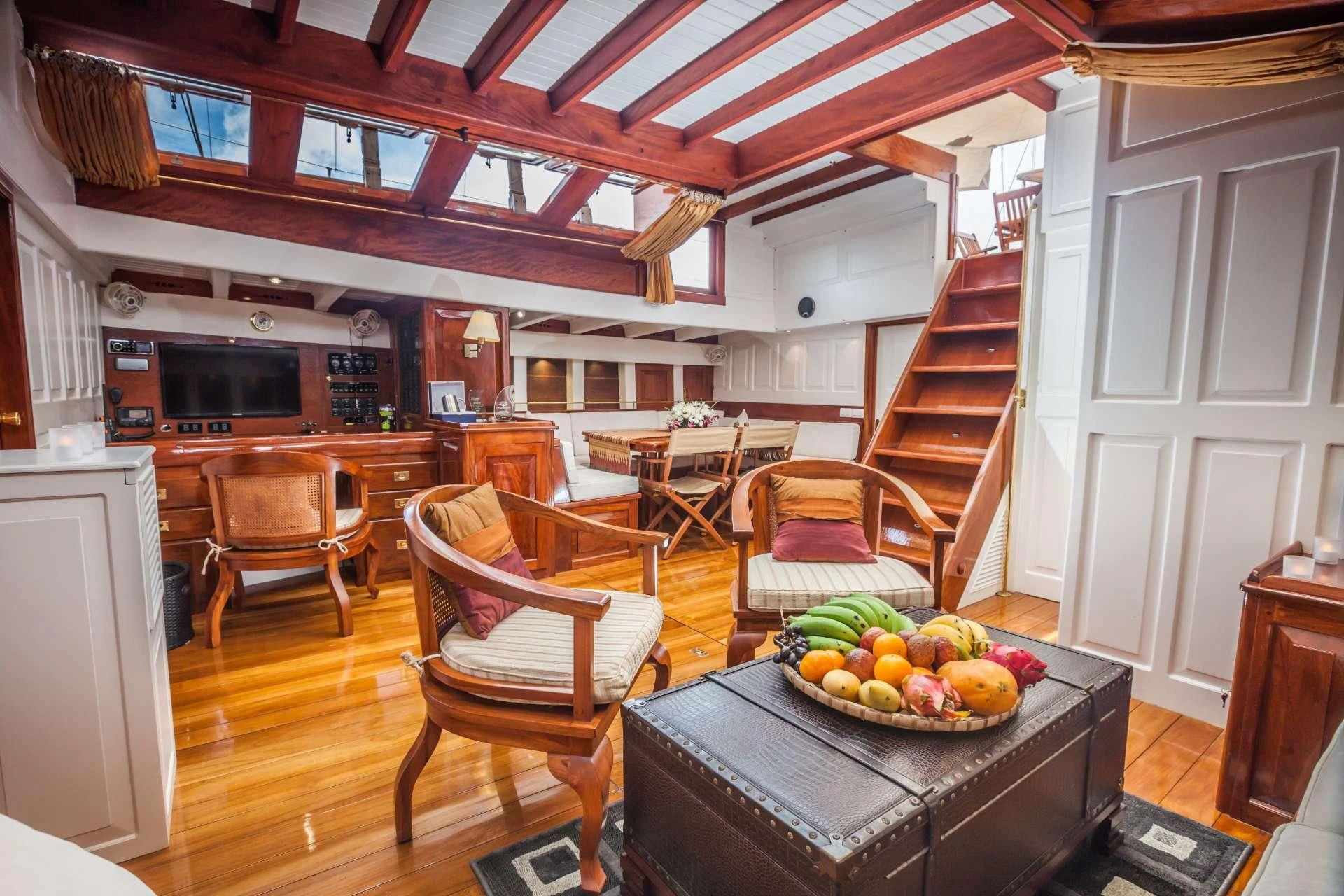 a kitchen with a table and chairs aboard AVENTURE Yacht for Sale