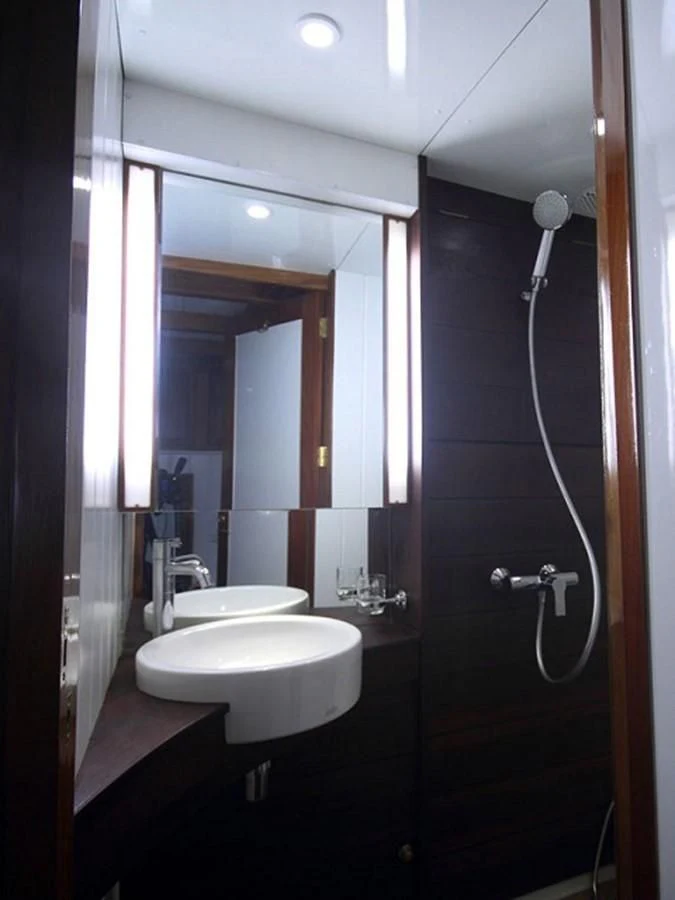 a bathroom with a sink and a mirror aboard AVENTURE Yacht for Sale