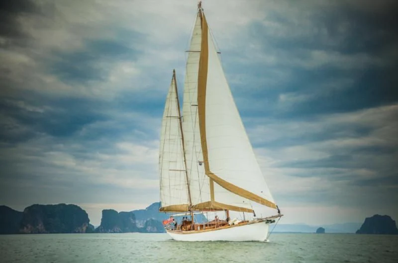 a sailboat on a beach aboard AVENTURE Yacht for Sale