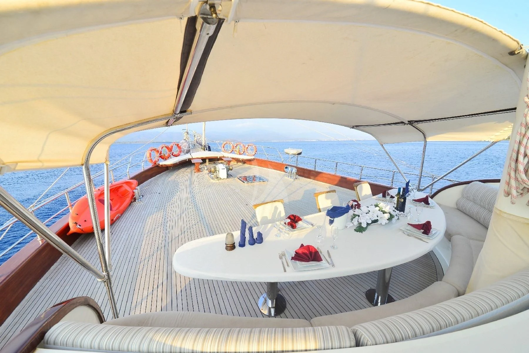 a boat with a table and chairs aboard BERRAK SU Yacht for Sale