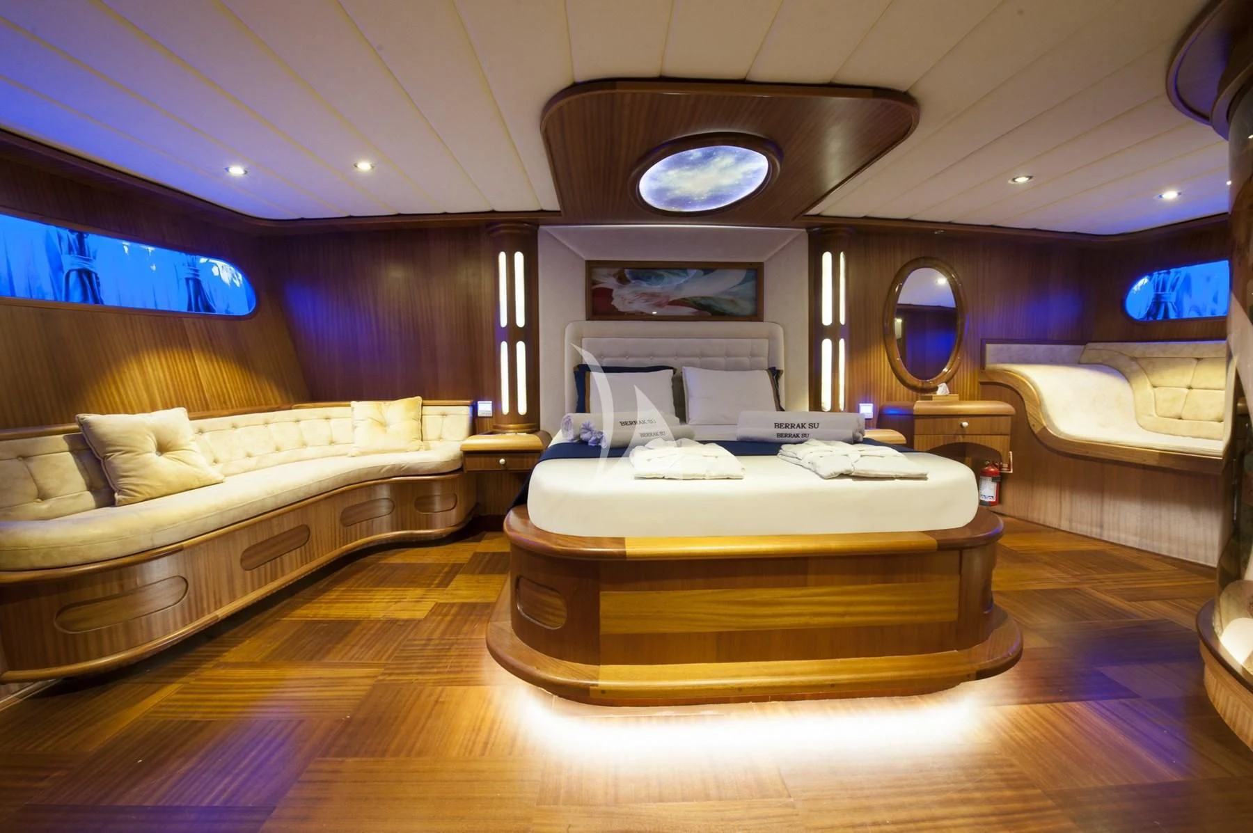 a large living room with a large round mirror aboard BERRAK SU Yacht for Sale