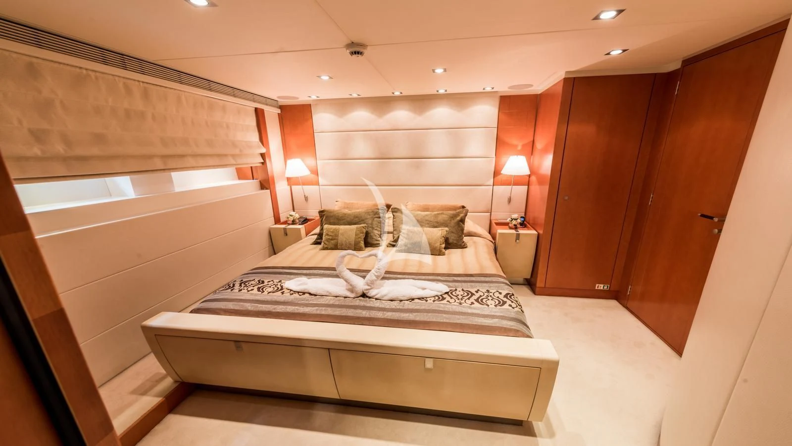a room with a bed and a lamp aboard AGRAM Yacht for Charter
