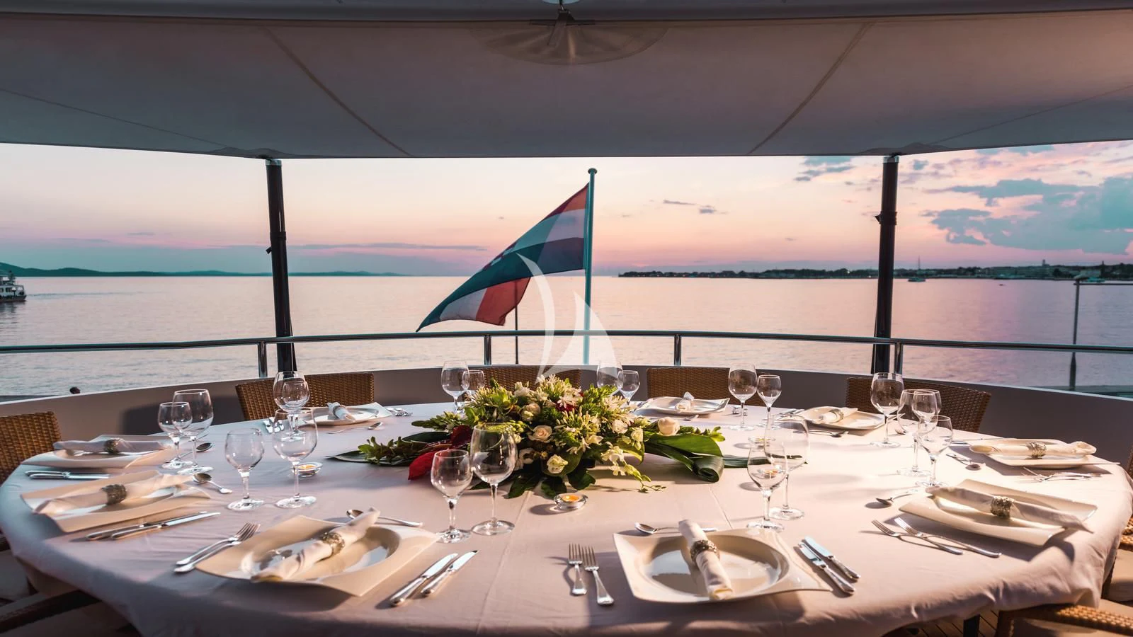 a table set with place settings aboard AGRAM Yacht for Charter