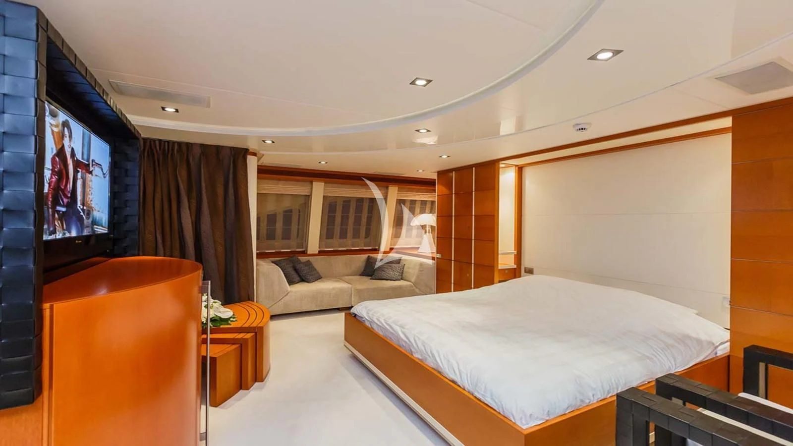 a room with a bed and a television aboard AGRAM Yacht for Charter