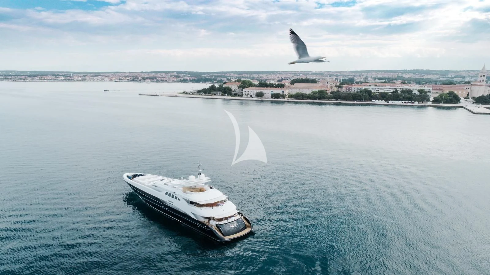 a plane flying over a boat in the water aboard AGRAM Yacht for Charter