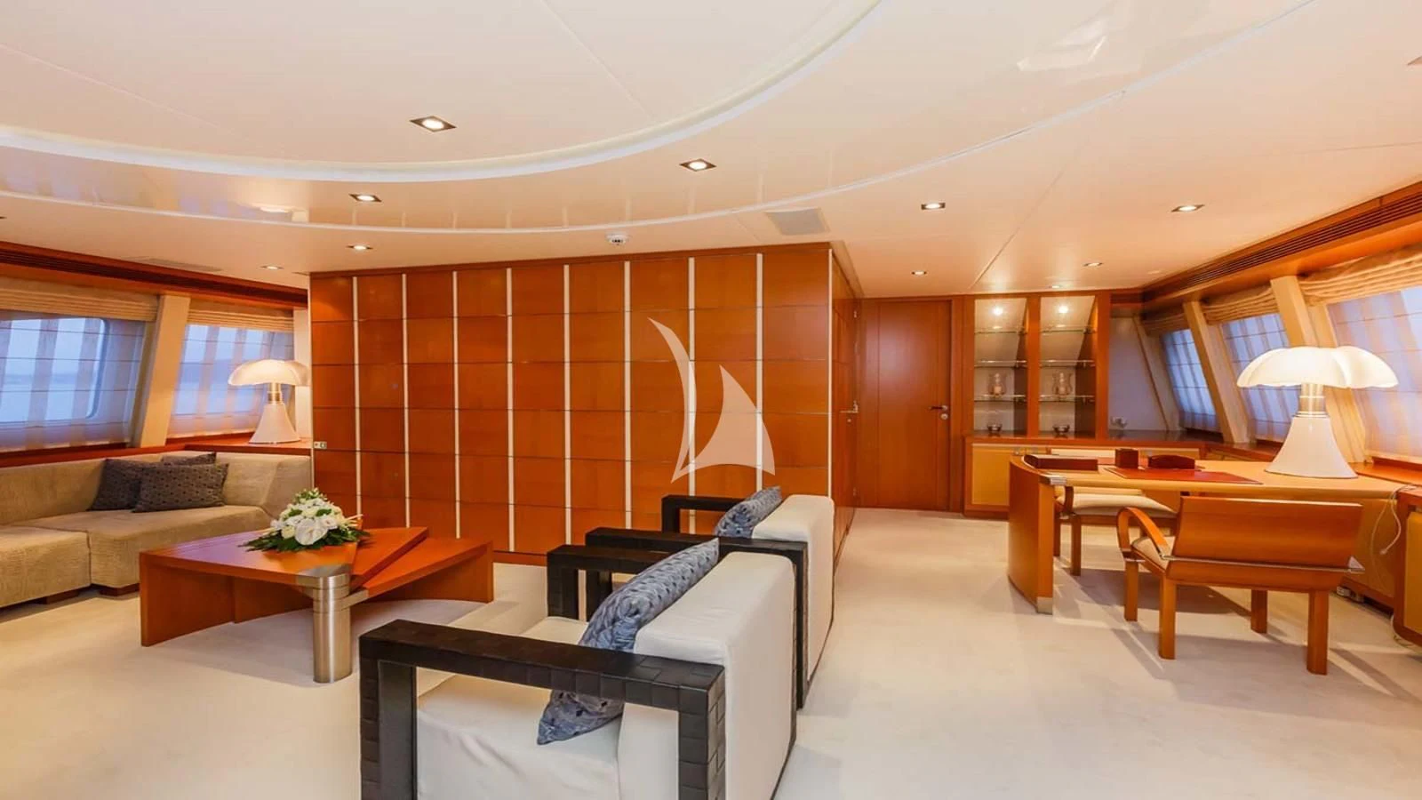 a room with a couch and a table and a chair aboard AGRAM Yacht for Charter